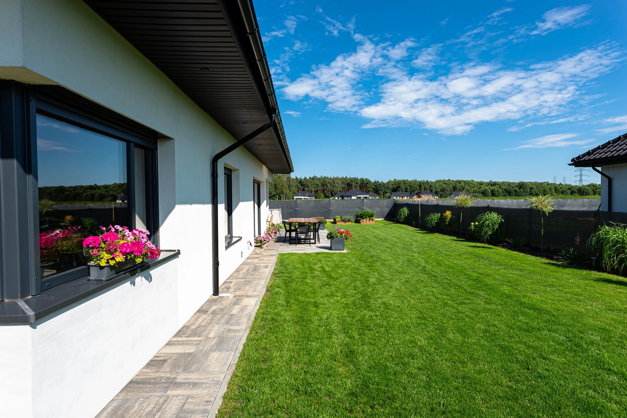 Residential home and yard representing attic insulation improvements
